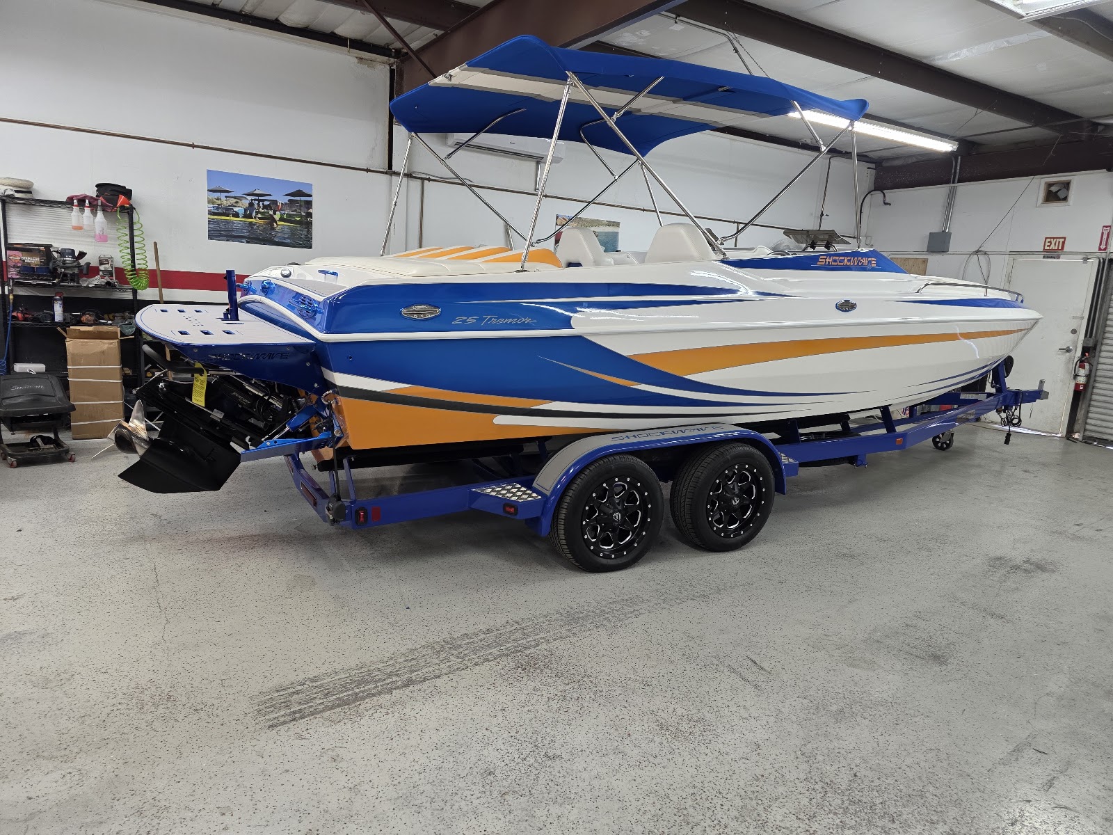 Blue and yellow performance boat in the shop with a new swim platform