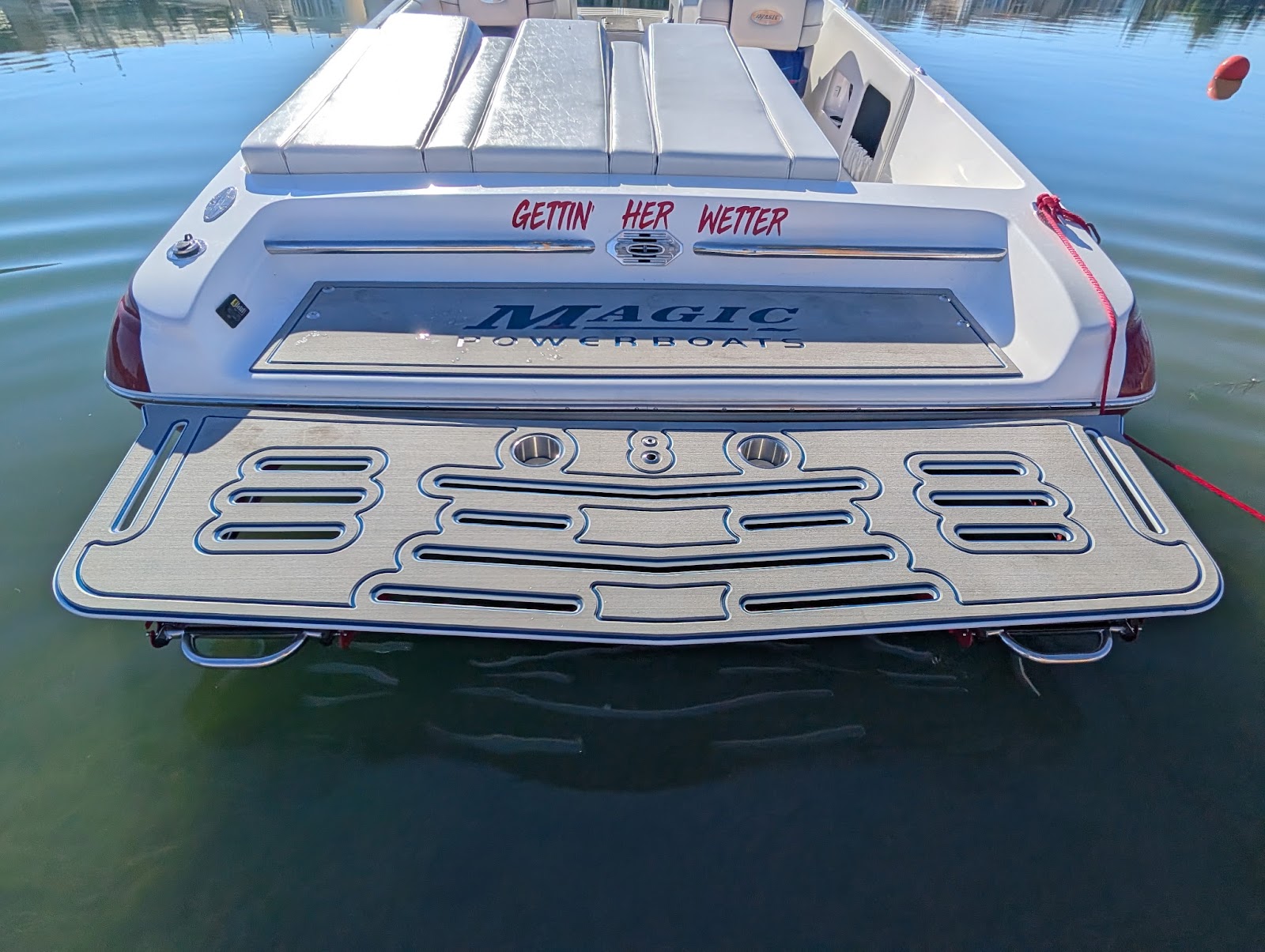 Custom swim platform with marine decking on a Magic boat in the water