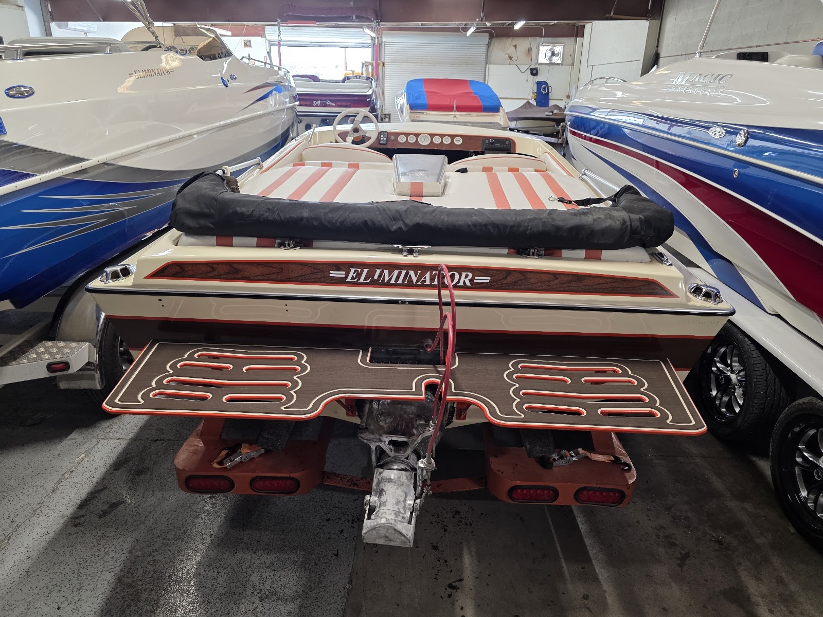 Eliminator boat in the shop with a two-tone custom swim platform