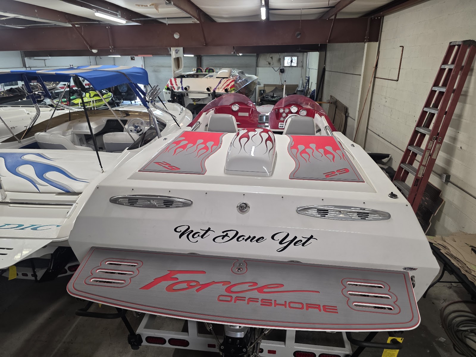 Force offshore boat in the shop with a custom swim platform