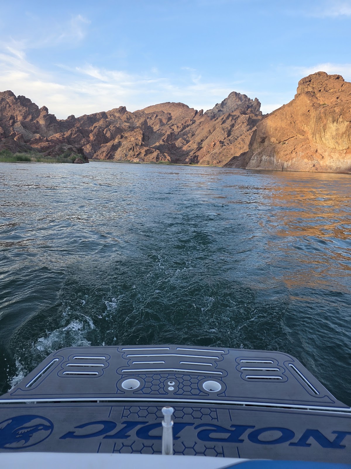 View over marine decking toward sunset cliffs on the lake