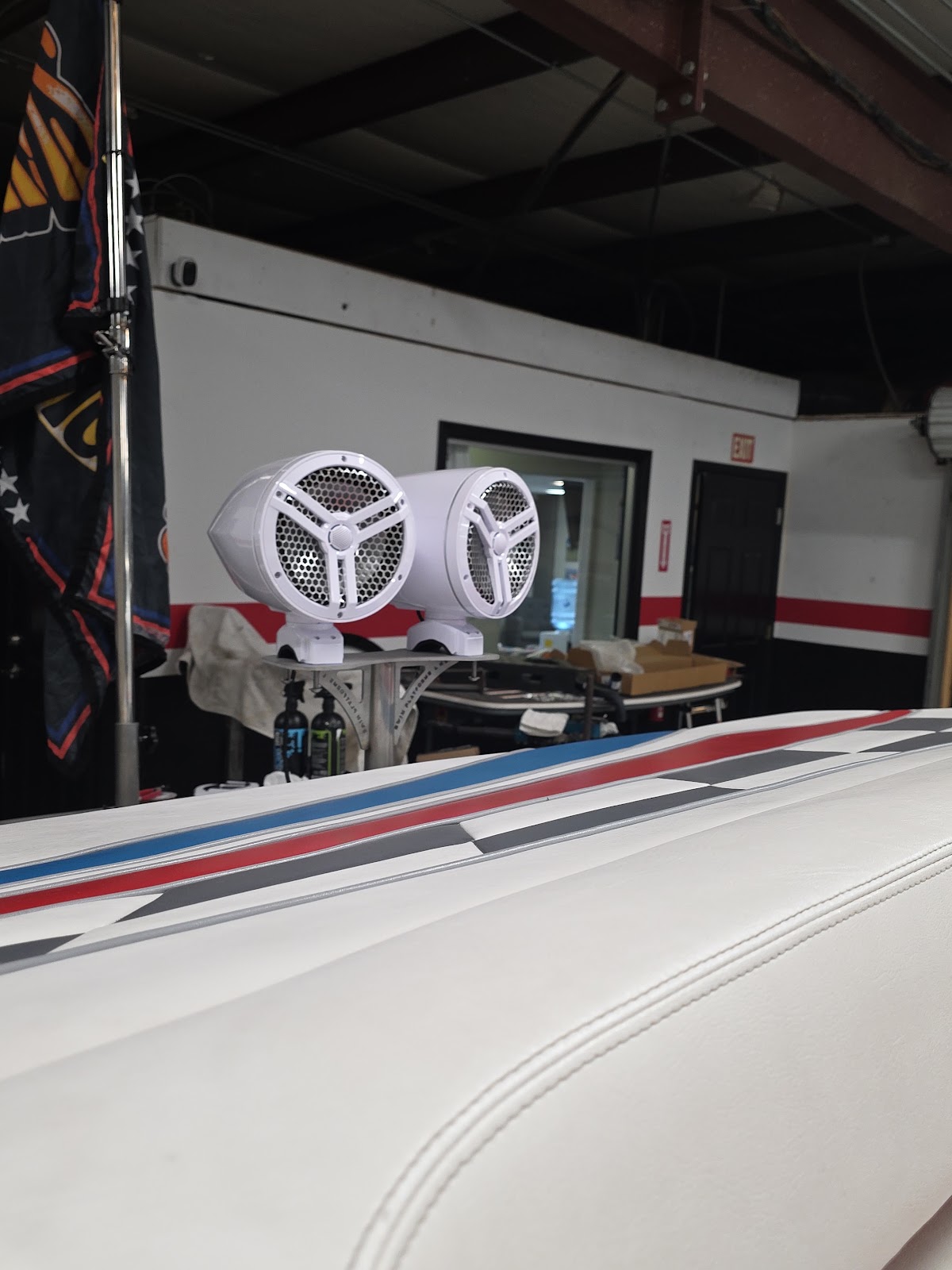 White marine speaker pods mounted on a boat in the shop