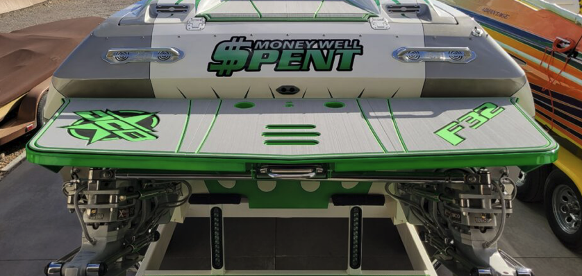 Custom aluminium swim platform with green trim and matching SeaDek decking fitted to the transom of a silver and green performance boat