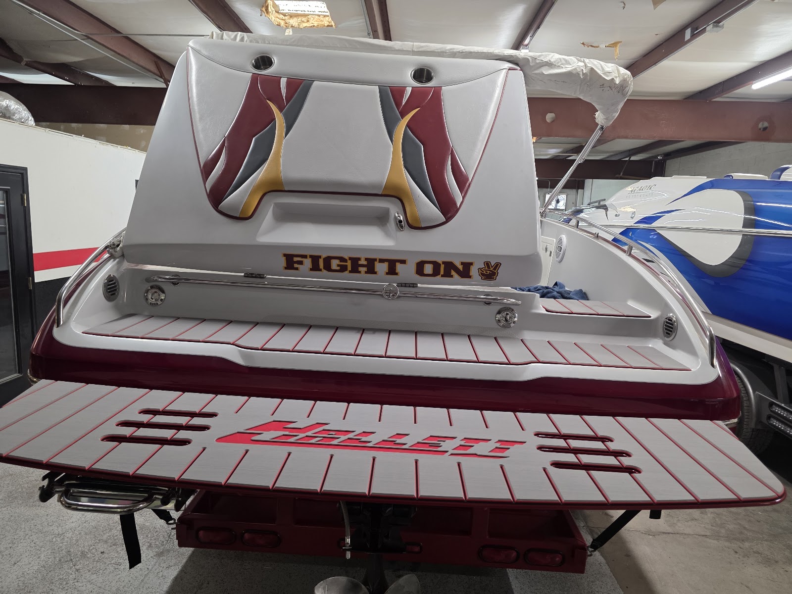 White and red boat with a red-decked custom swim platform