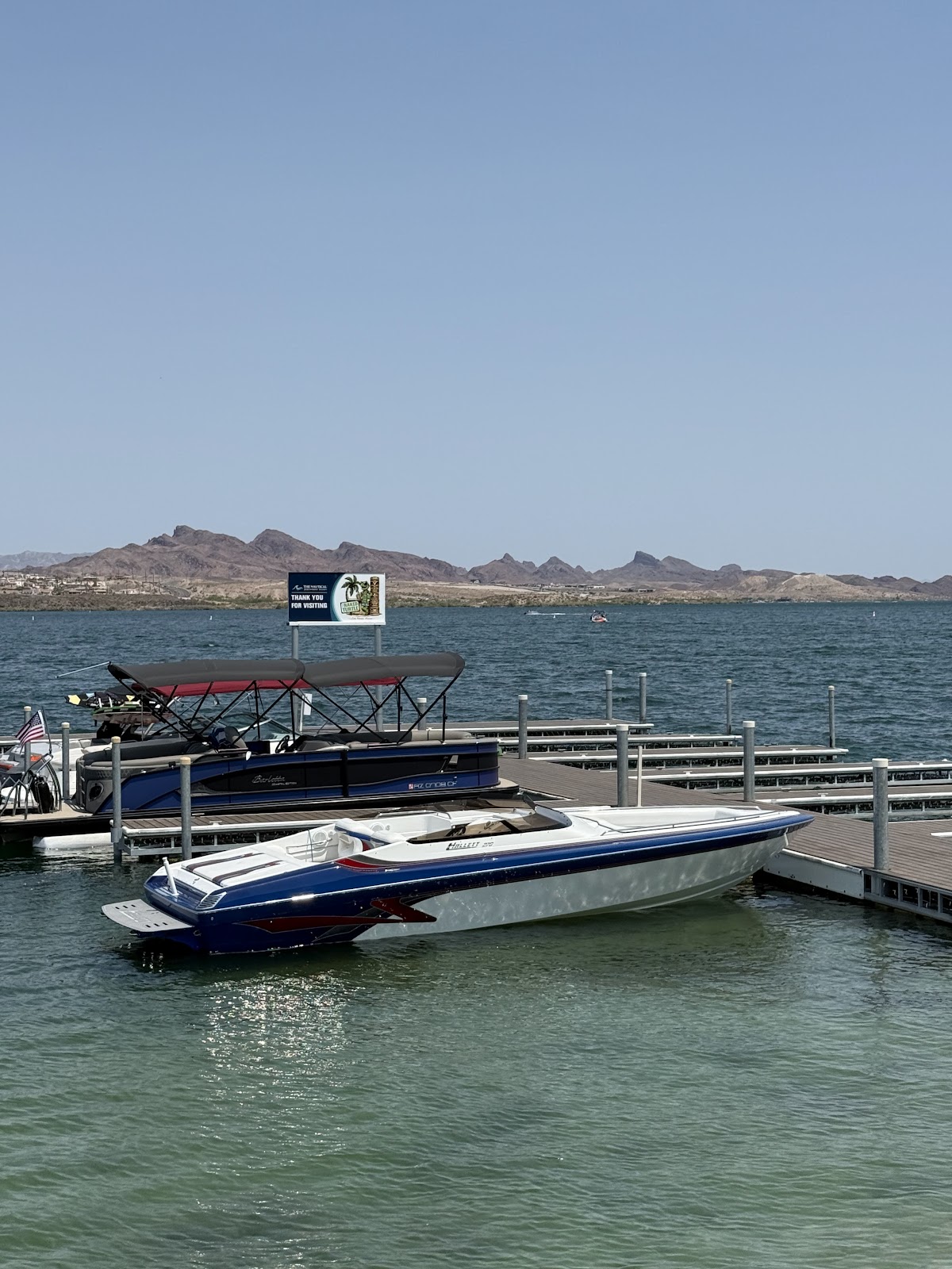 Performance boat tied at the dock showing its custom swim platform