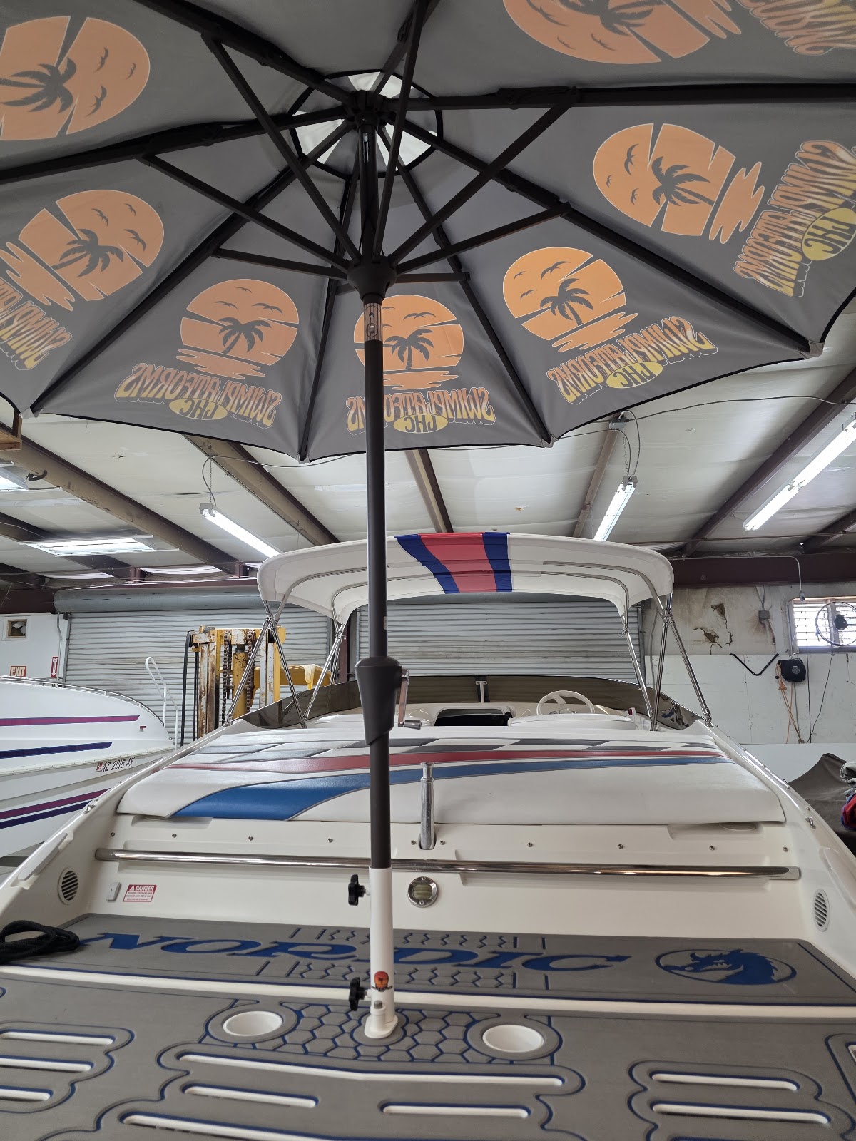 View from under a printed umbrella mounted over a swim platform