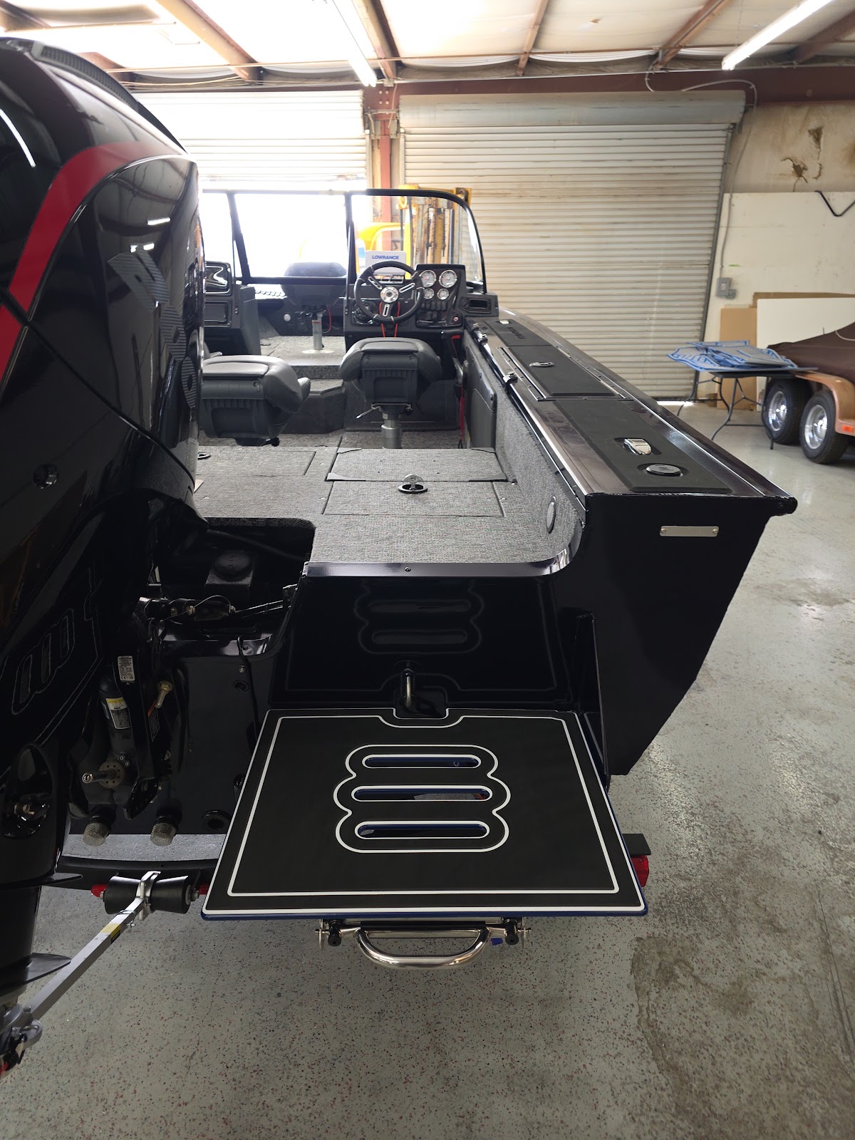 Boat in the shop fitted with a gray patterned swim platform deck