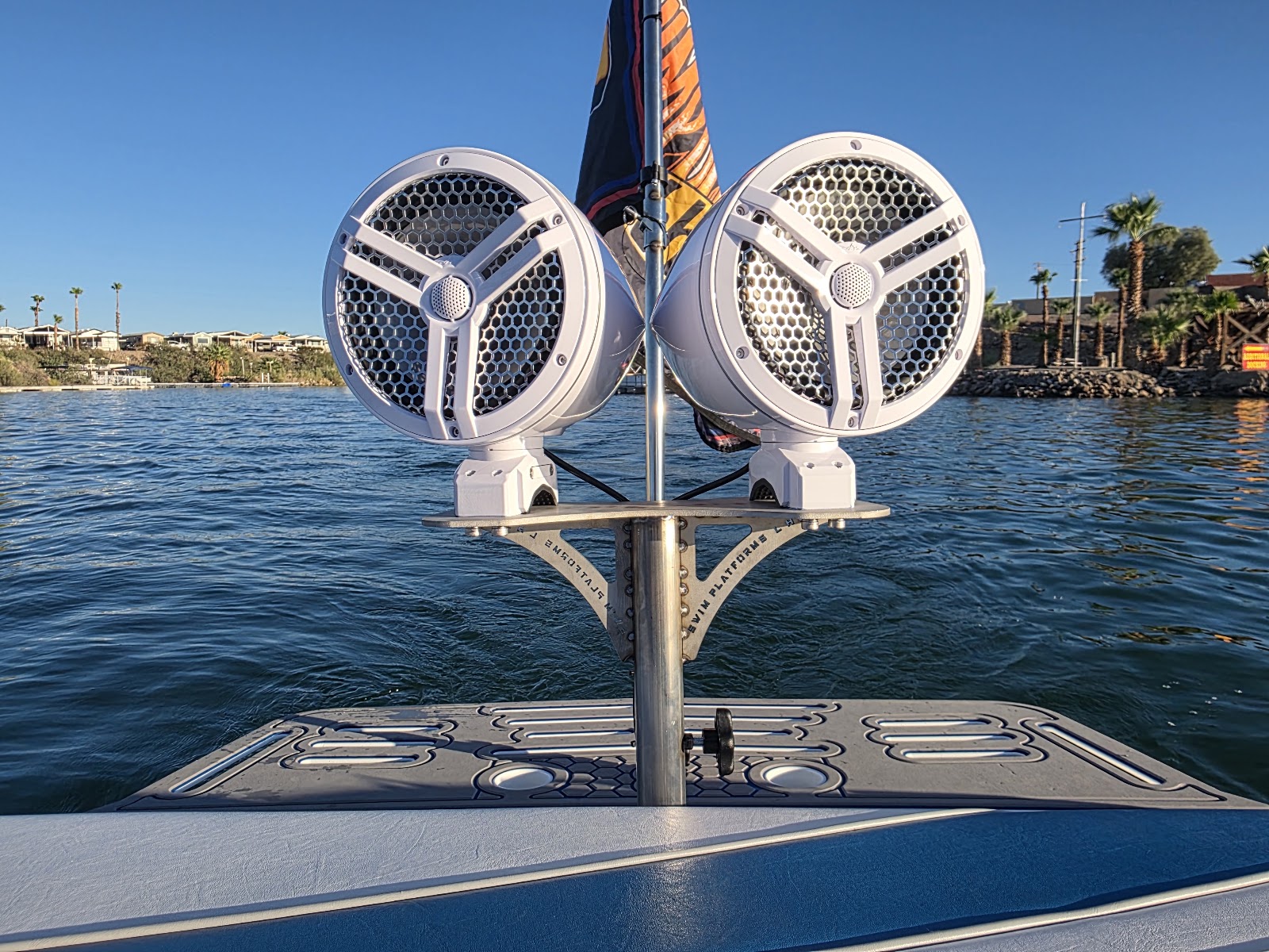 Speaker pods mounted on a ski pole over the lake