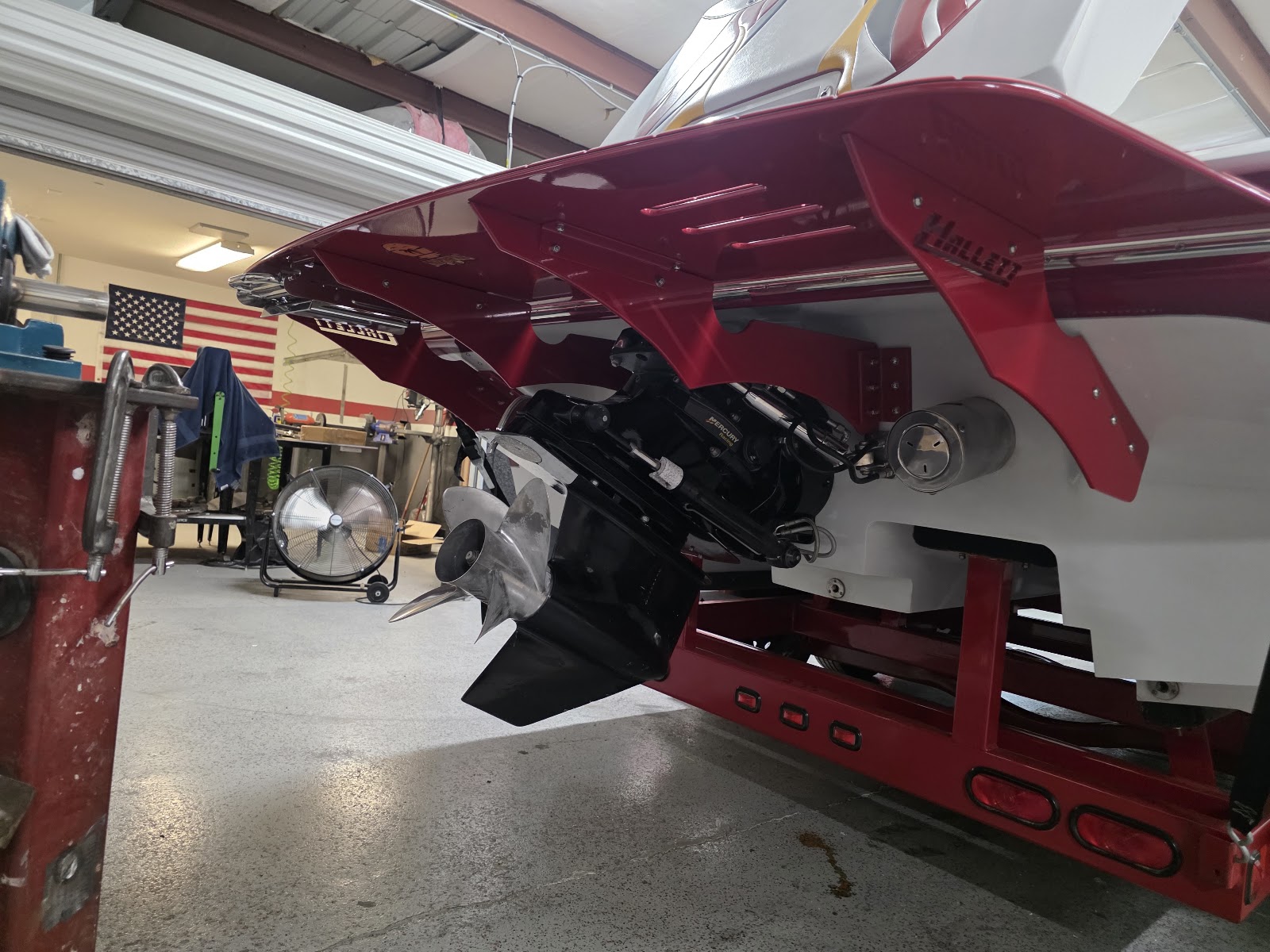 Red boat with matching red swim platform hardware in the shop