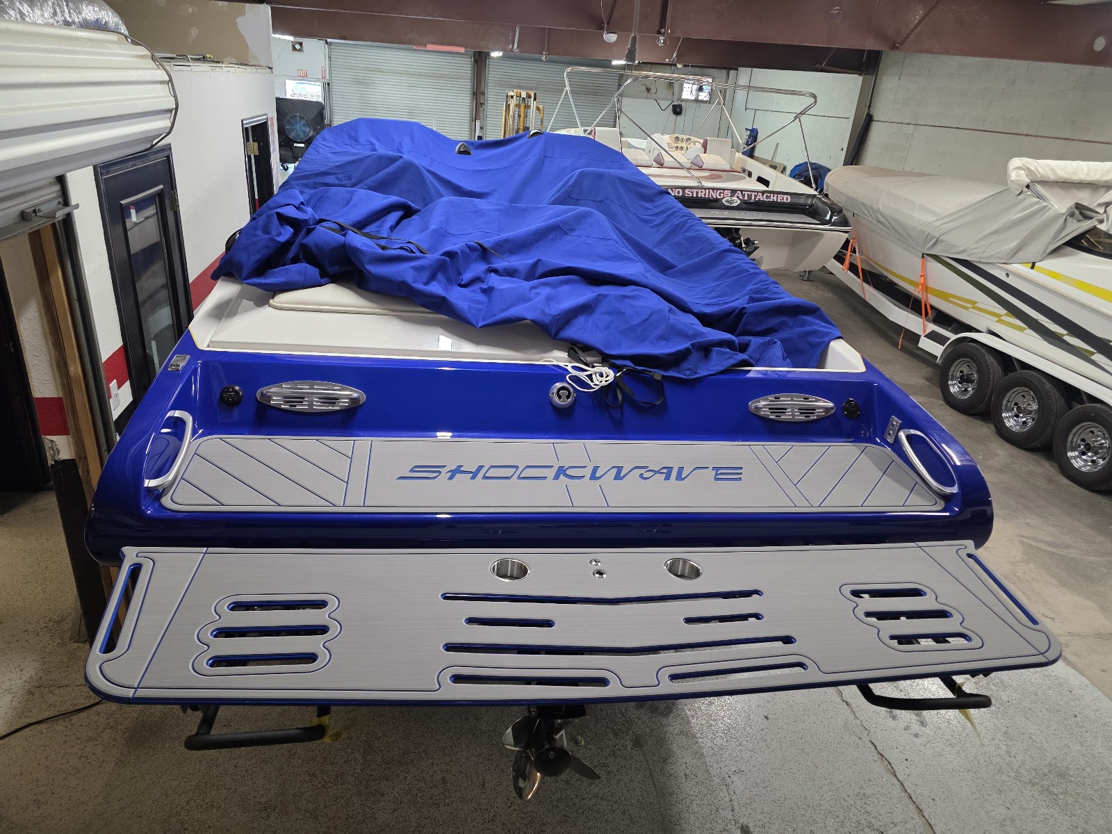 Blue Shockwave boat in the shop with a new swim platform
