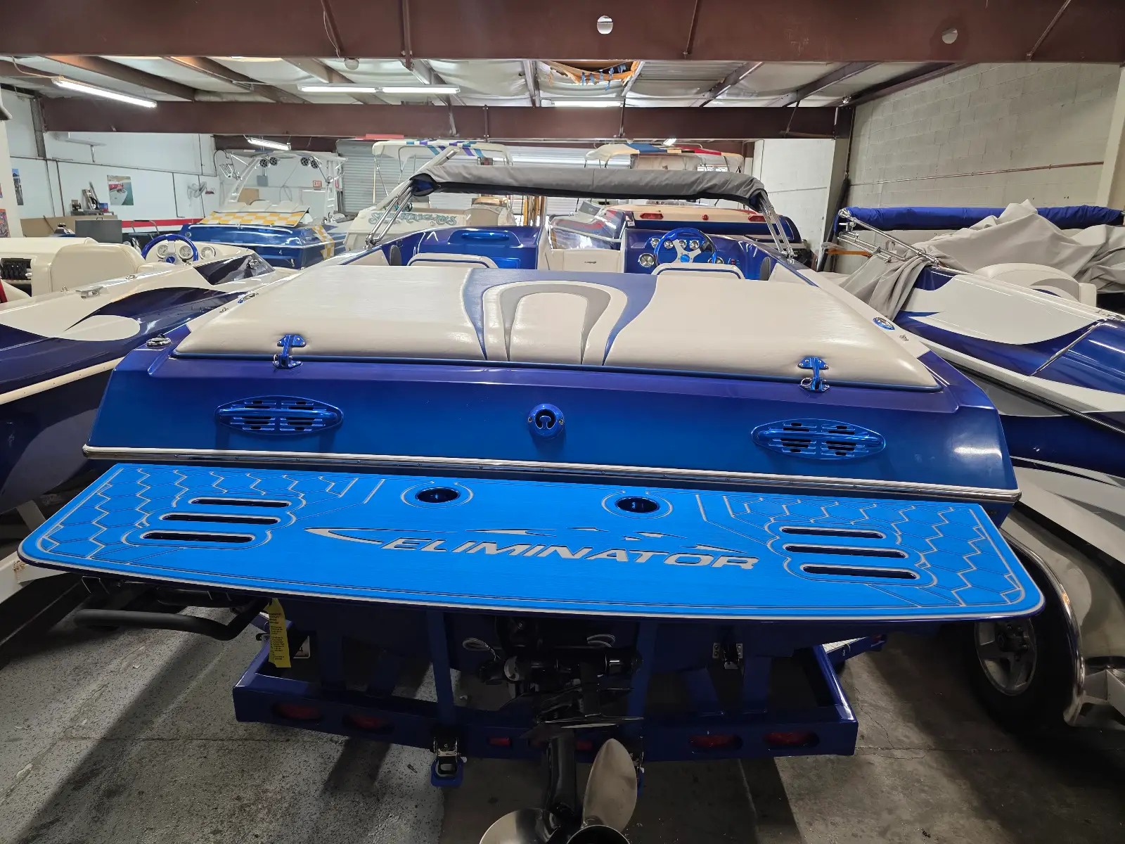 Blue Eliminator boat on the hoist with a blue swim platform