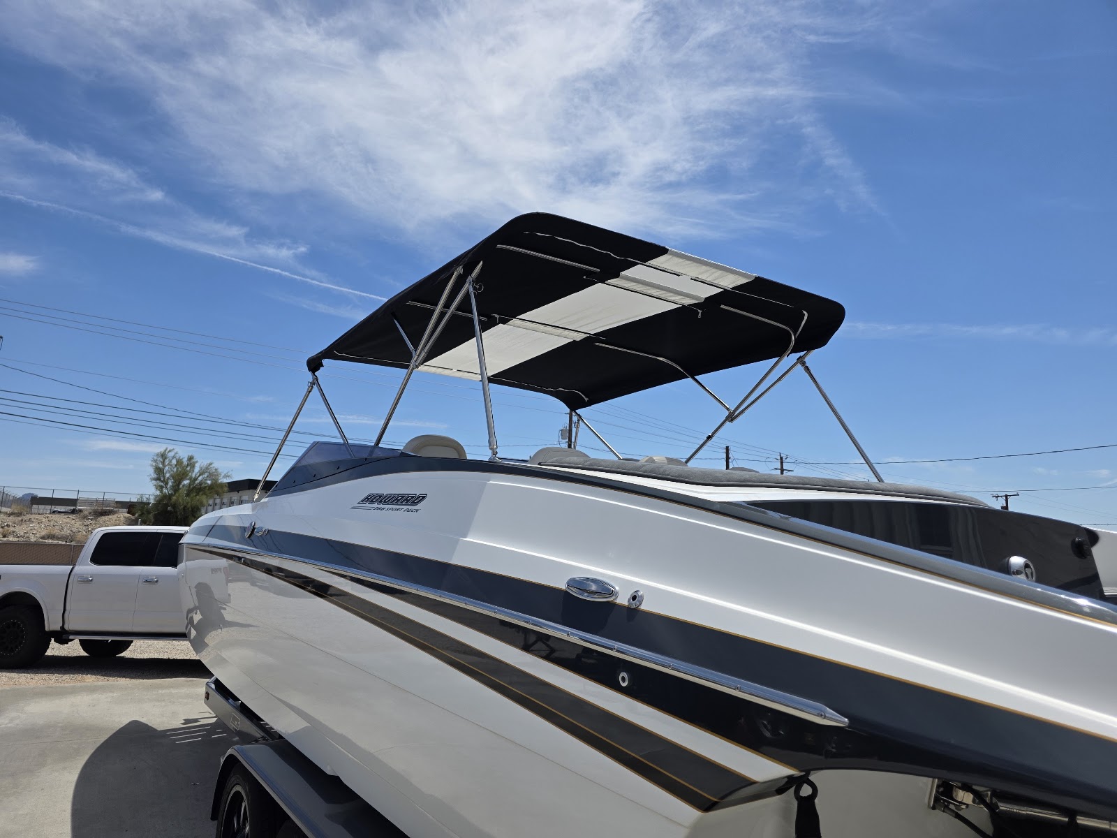 Black and white bimini top with stainless frame on a performance boat