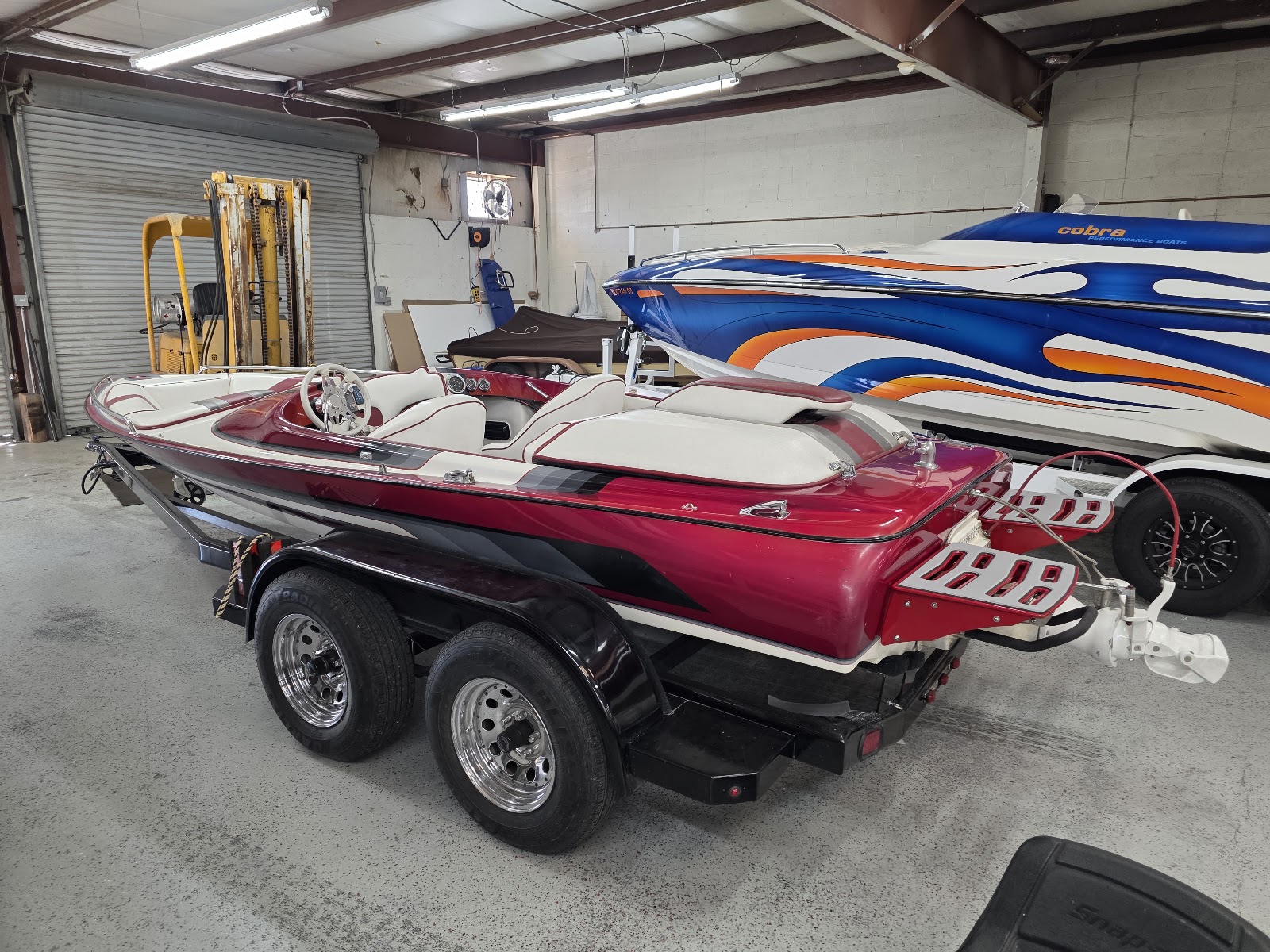 Red and white boat on its trailer with a finished swim platform